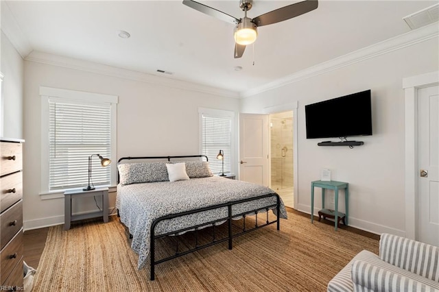 bedroom featuring hardwood / wood-style flooring, ornamental molding, ceiling fan, and ensuite bath