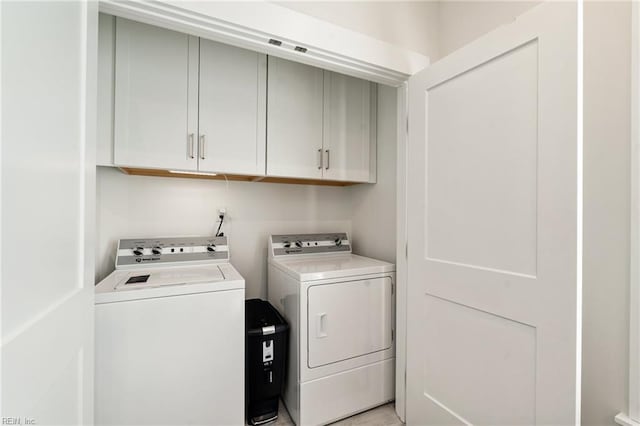 laundry area with cabinets and separate washer and dryer