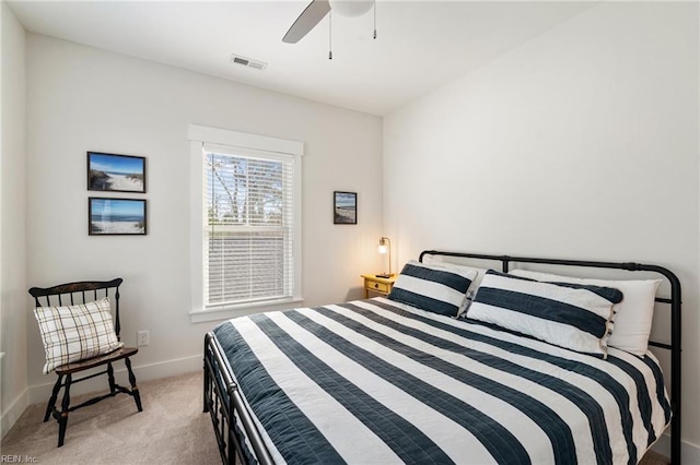 bedroom featuring light colored carpet and ceiling fan