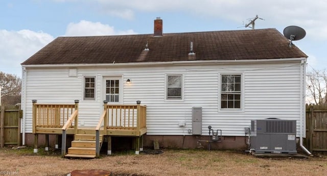 rear view of house featuring a wooden deck and central air condition unit