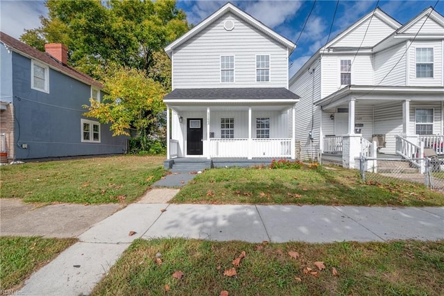 view of front of house featuring a front yard and covered porch