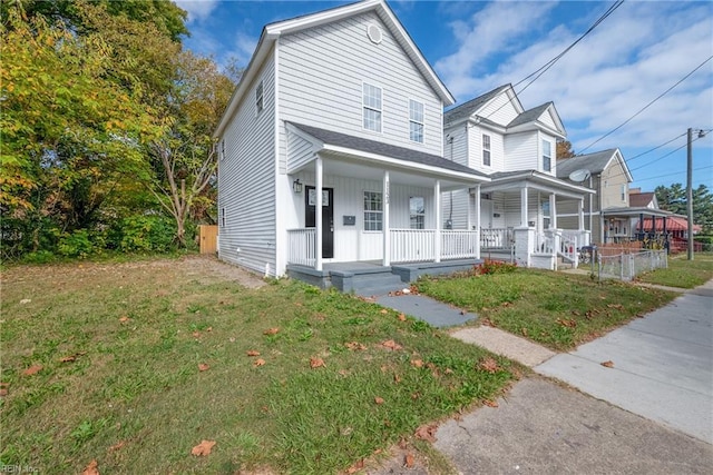 view of front of house with covered porch and a front lawn