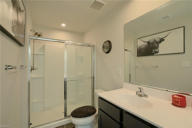 bathroom featuring walk in shower, vanity, and toilet