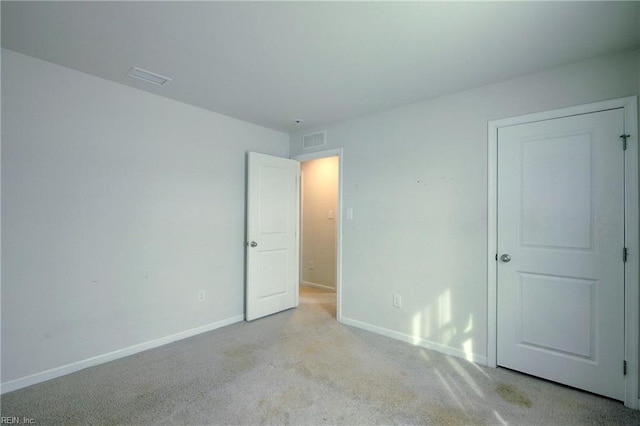 unfurnished room with light carpet