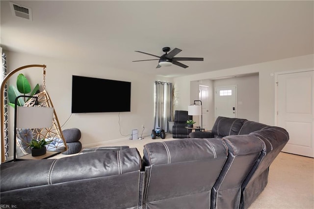 carpeted living room with ceiling fan