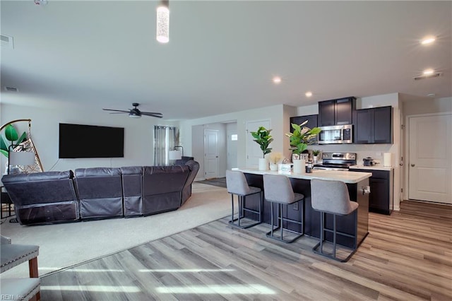 interior space with ceiling fan and light hardwood / wood-style floors