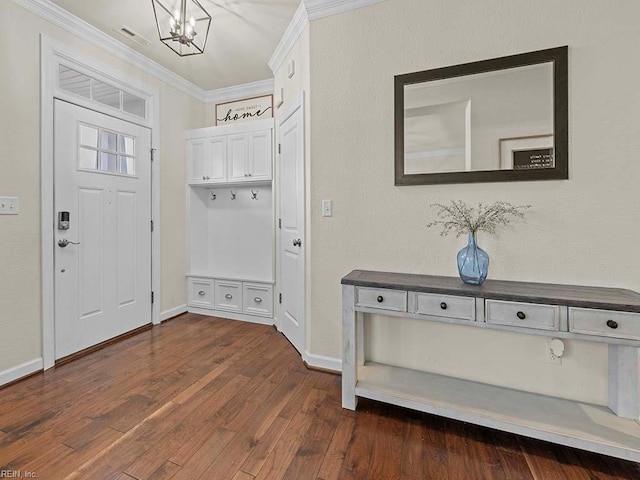 entryway with an inviting chandelier, crown molding, and dark wood-type flooring