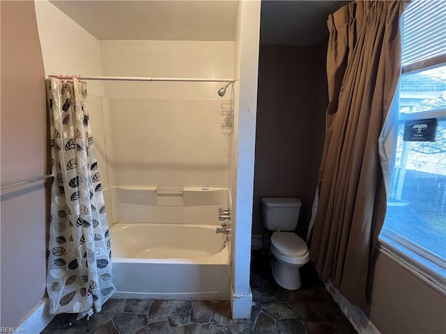 bathroom featuring toilet and shower / bathtub combination with curtain