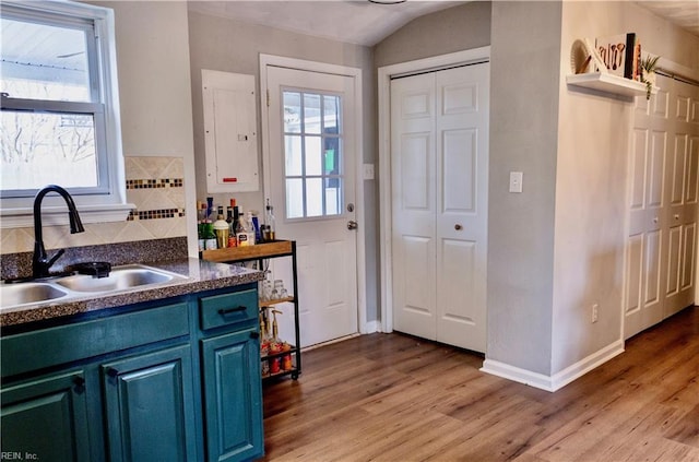 kitchen featuring plenty of natural light, sink, and light wood-type flooring