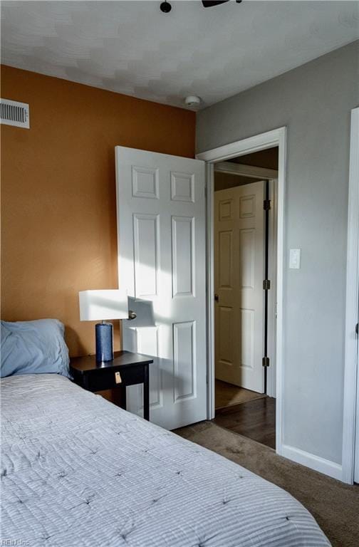 bedroom with dark colored carpet