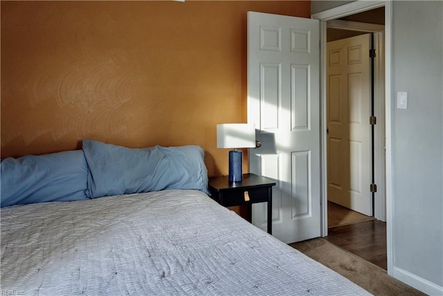 bedroom featuring dark colored carpet