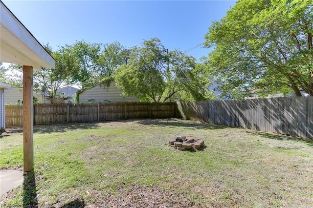 view of yard with a fire pit