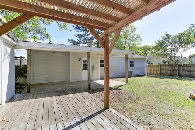 deck with a yard and central air condition unit