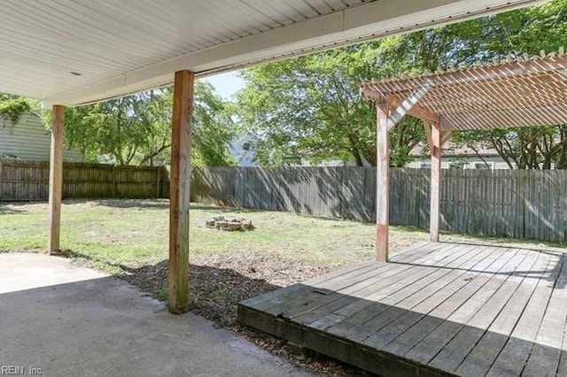 exterior space with a wooden deck, a pergola, and a patio area