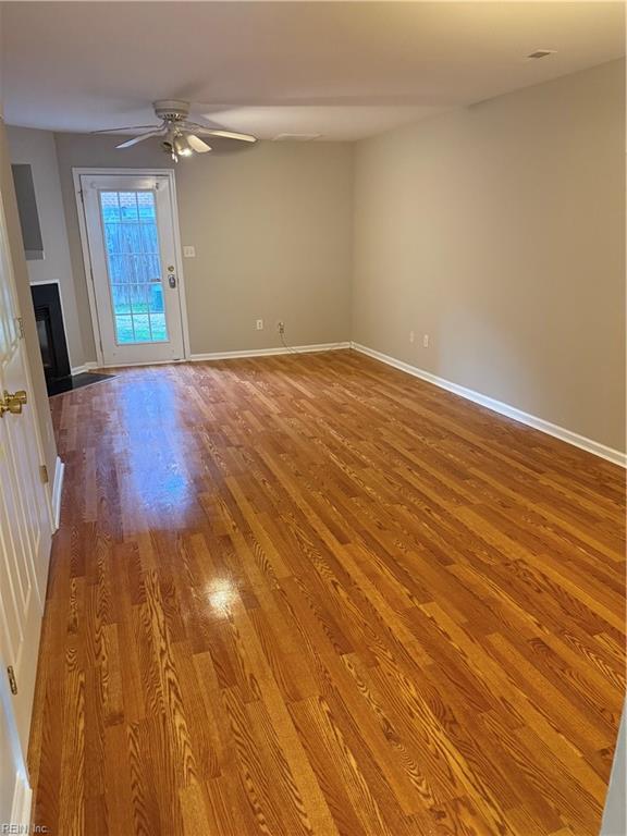 unfurnished living room featuring ceiling fan and wood-type flooring