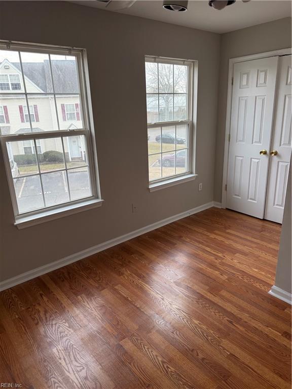 unfurnished room with hardwood / wood-style flooring