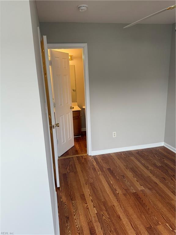 unfurnished room featuring dark hardwood / wood-style flooring