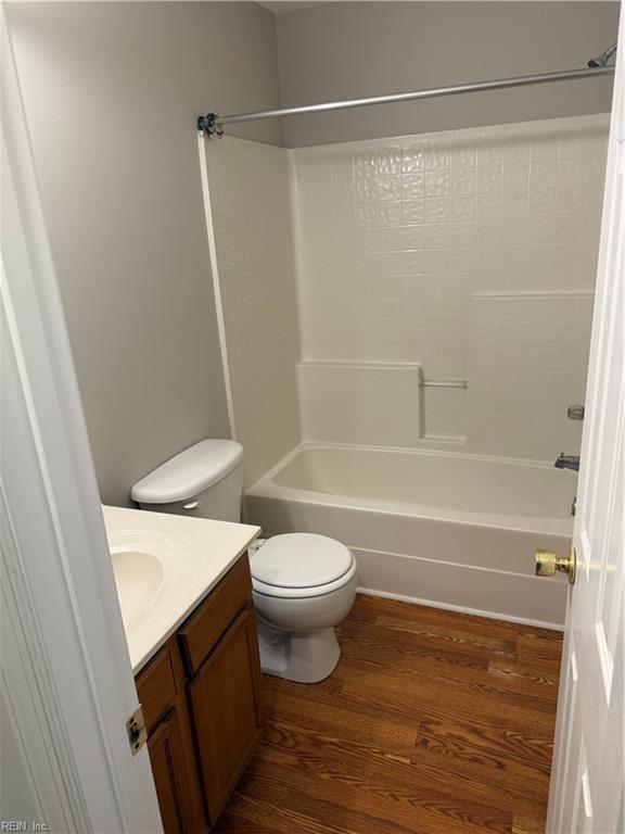 full bathroom featuring shower / tub combination, vanity, toilet, and hardwood / wood-style floors