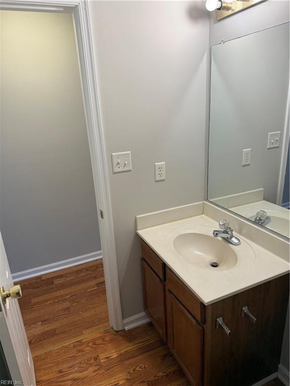 bathroom with vanity and hardwood / wood-style flooring