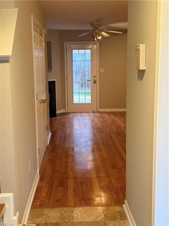 doorway featuring hardwood / wood-style floors and ceiling fan