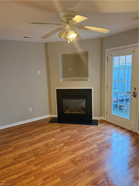 unfurnished living room featuring ceiling fan and light hardwood / wood-style floors