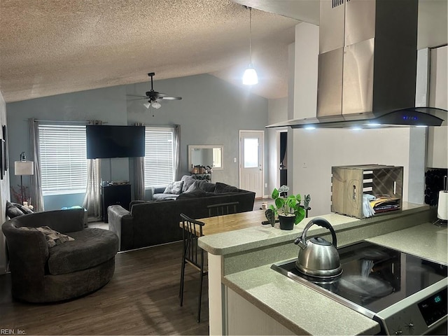 kitchen with a textured ceiling, range with electric stovetop, dark hardwood / wood-style flooring, pendant lighting, and range hood