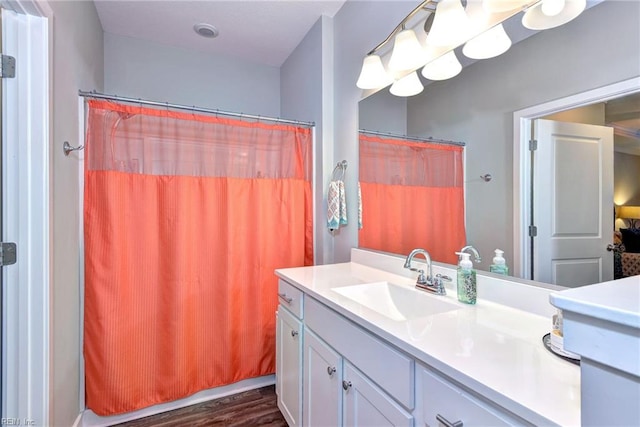 bathroom featuring vanity, hardwood / wood-style flooring, and walk in shower