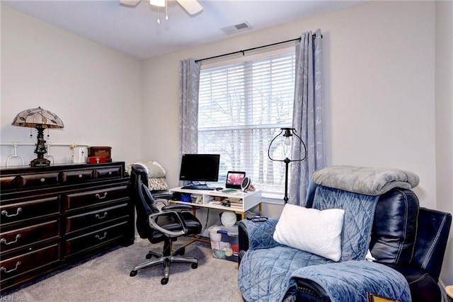 office space with light carpet, plenty of natural light, and ceiling fan