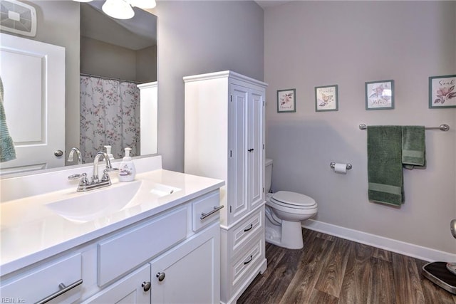 bathroom featuring vanity, hardwood / wood-style flooring, and toilet