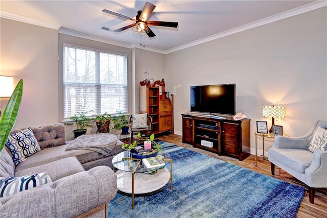 living room featuring crown molding, wood-type flooring, and ceiling fan