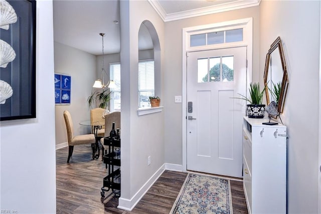 foyer featuring ornamental molding and dark hardwood / wood-style floors