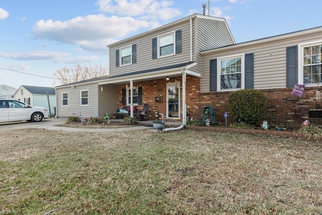 view of front of house with a front yard and a porch