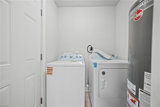 laundry room with washing machine and dryer and water heater