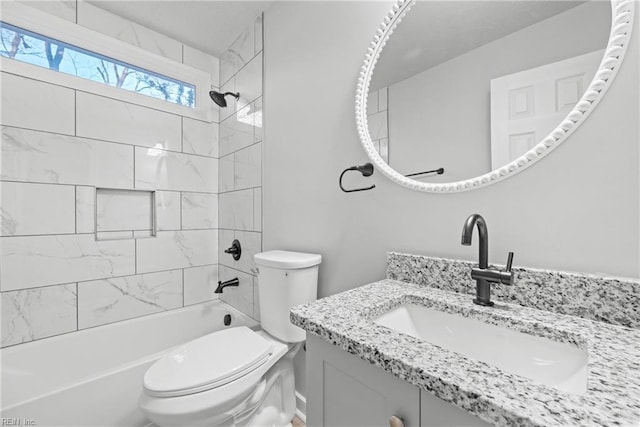 full bathroom with tiled shower / bath combo, vanity, and toilet