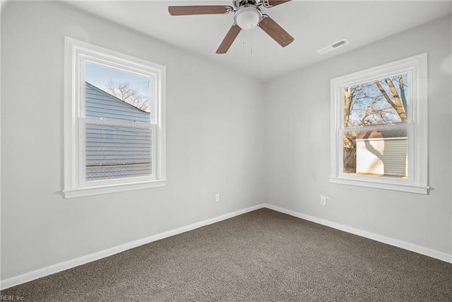 empty room with ceiling fan and carpet floors