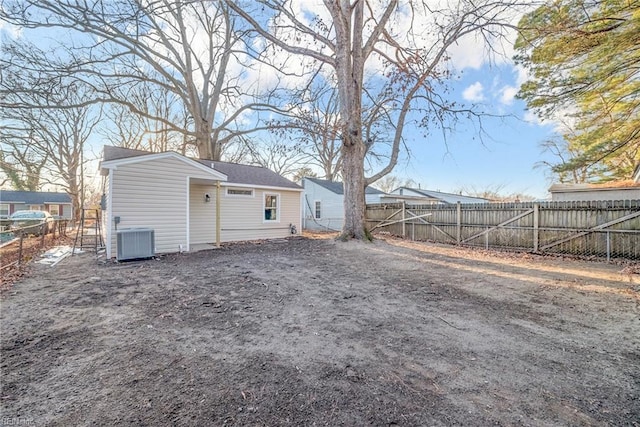 back of house with central AC unit