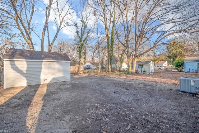 view of yard with central AC and a shed