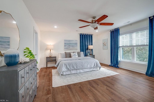 bedroom with hardwood / wood-style floors and ceiling fan