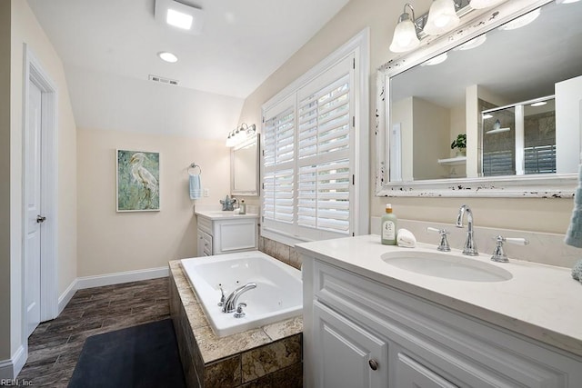 bathroom with hardwood / wood-style flooring, vanity, and independent shower and bath