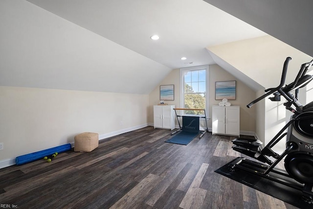 exercise room featuring vaulted ceiling and dark wood-type flooring