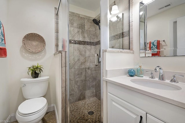 bathroom with walk in shower, vanity, and toilet