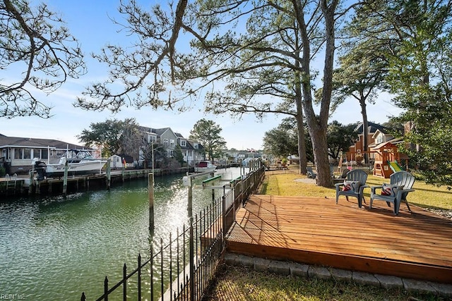 view of dock featuring a water view and a playground