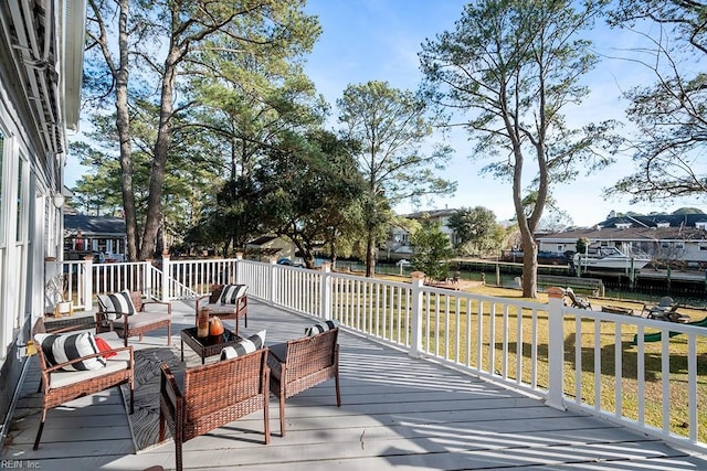 wooden terrace with a yard and an outdoor hangout area