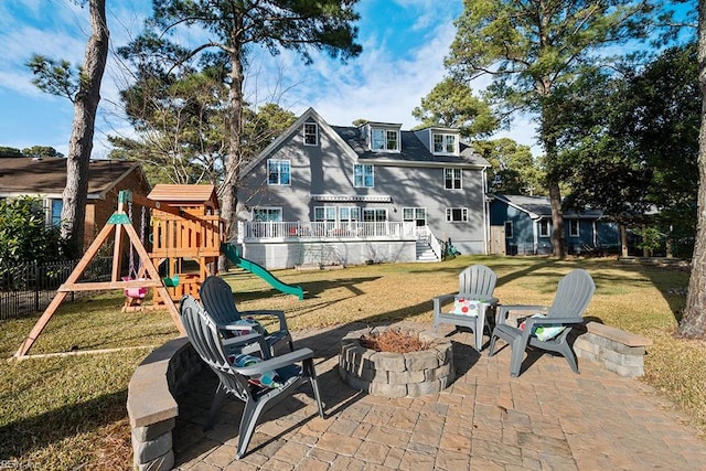 exterior space featuring a playground and an outdoor fire pit