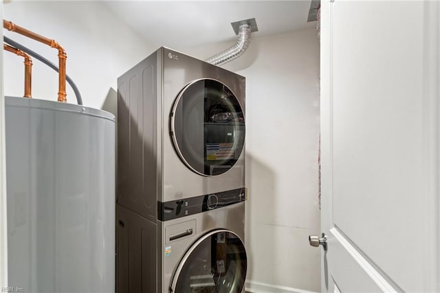 laundry area featuring stacked washer and dryer and water heater