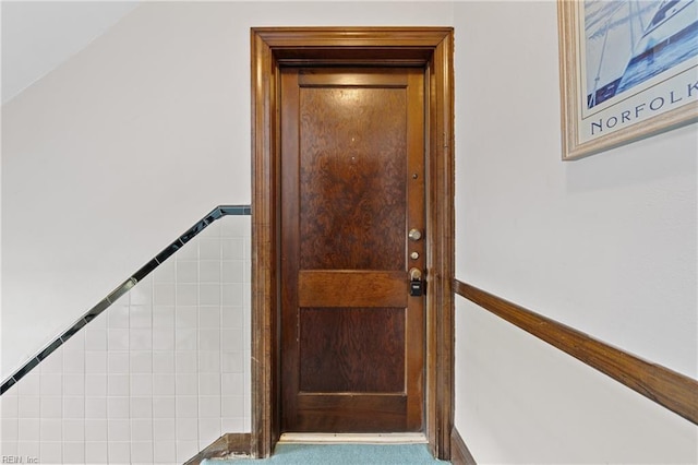 doorway with tile walls