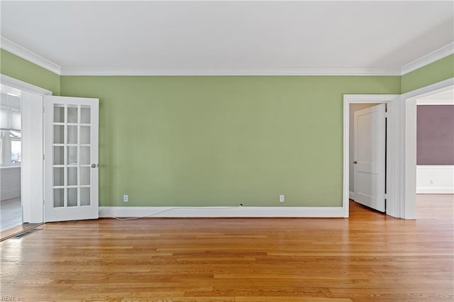 unfurnished room featuring ornamental molding and light hardwood / wood-style floors