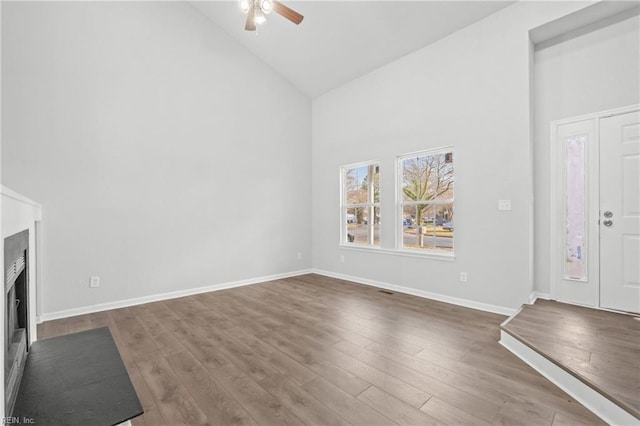 entrance foyer with ceiling fan, wood-type flooring, and high vaulted ceiling