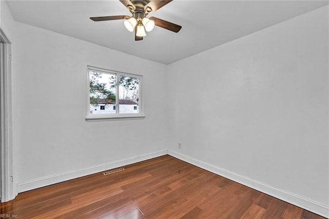 spare room with hardwood / wood-style flooring and ceiling fan