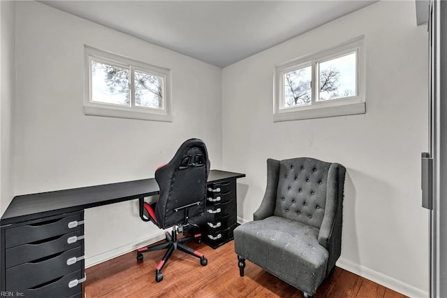 office space featuring dark wood-type flooring and a healthy amount of sunlight